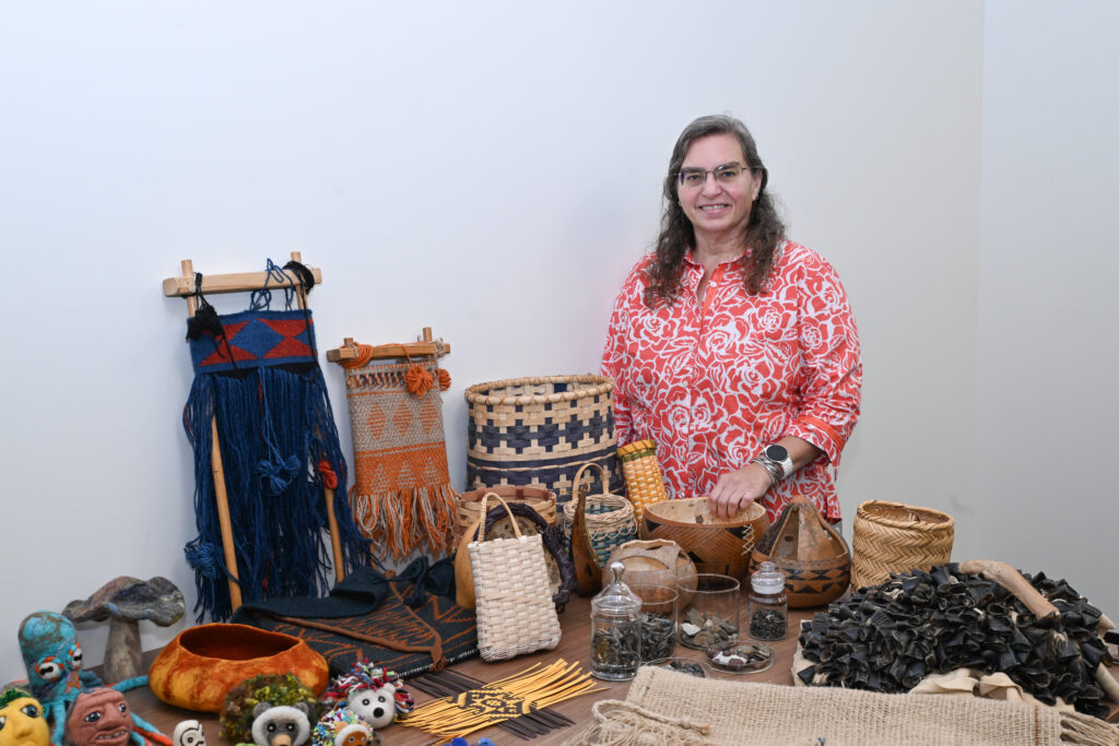 Monica Moore stands with handmade native American crafts