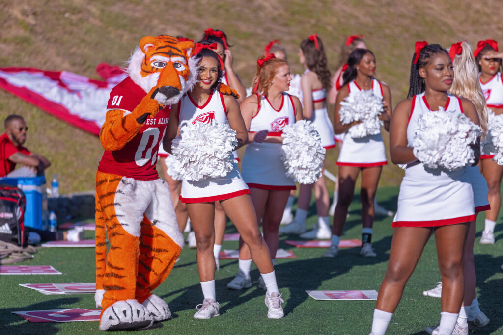 Tiger mascot LUie posing with Cheerleader