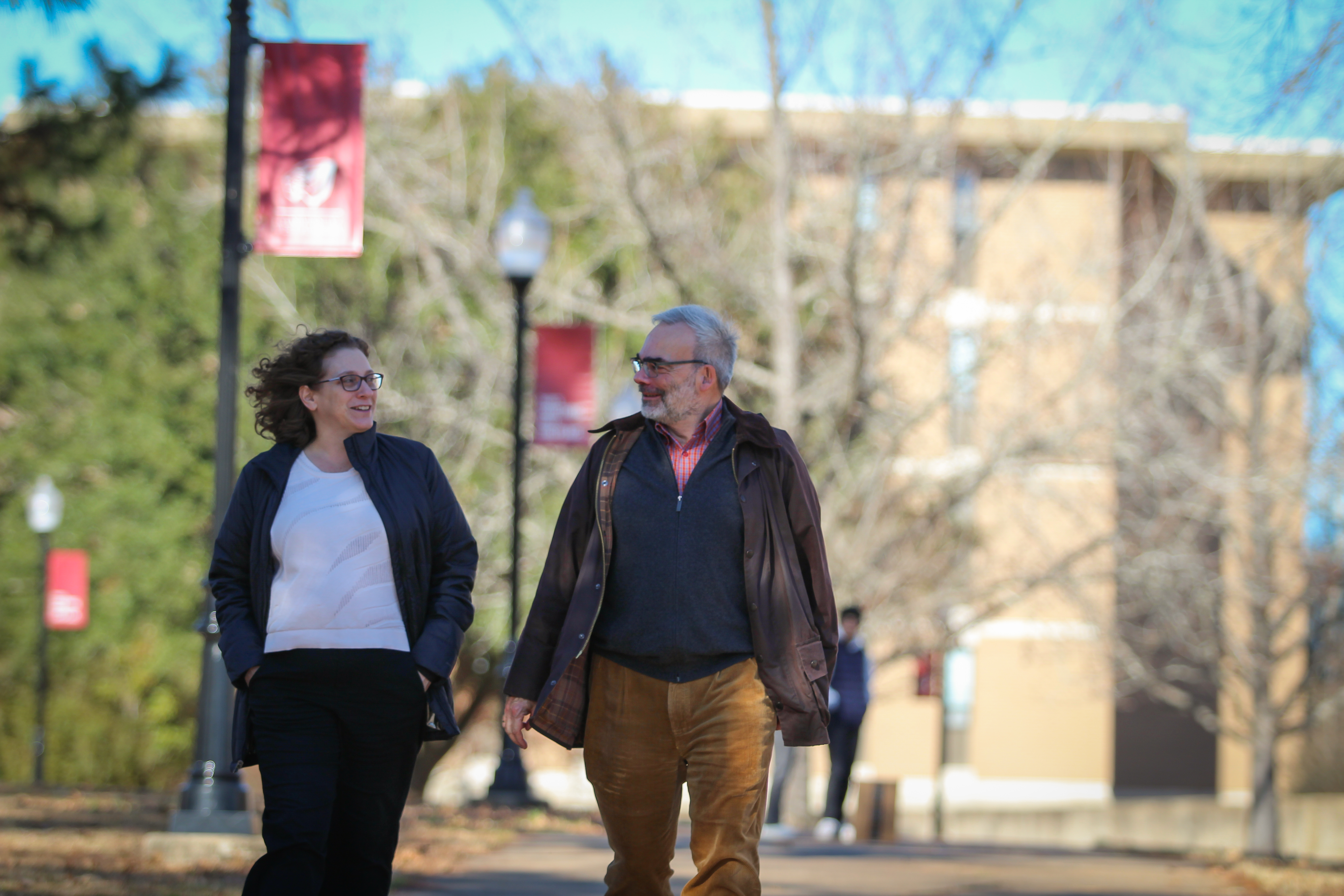 Dr. Ashley Dumas and Dr. Thomas Saile walk across the UWA campus.
