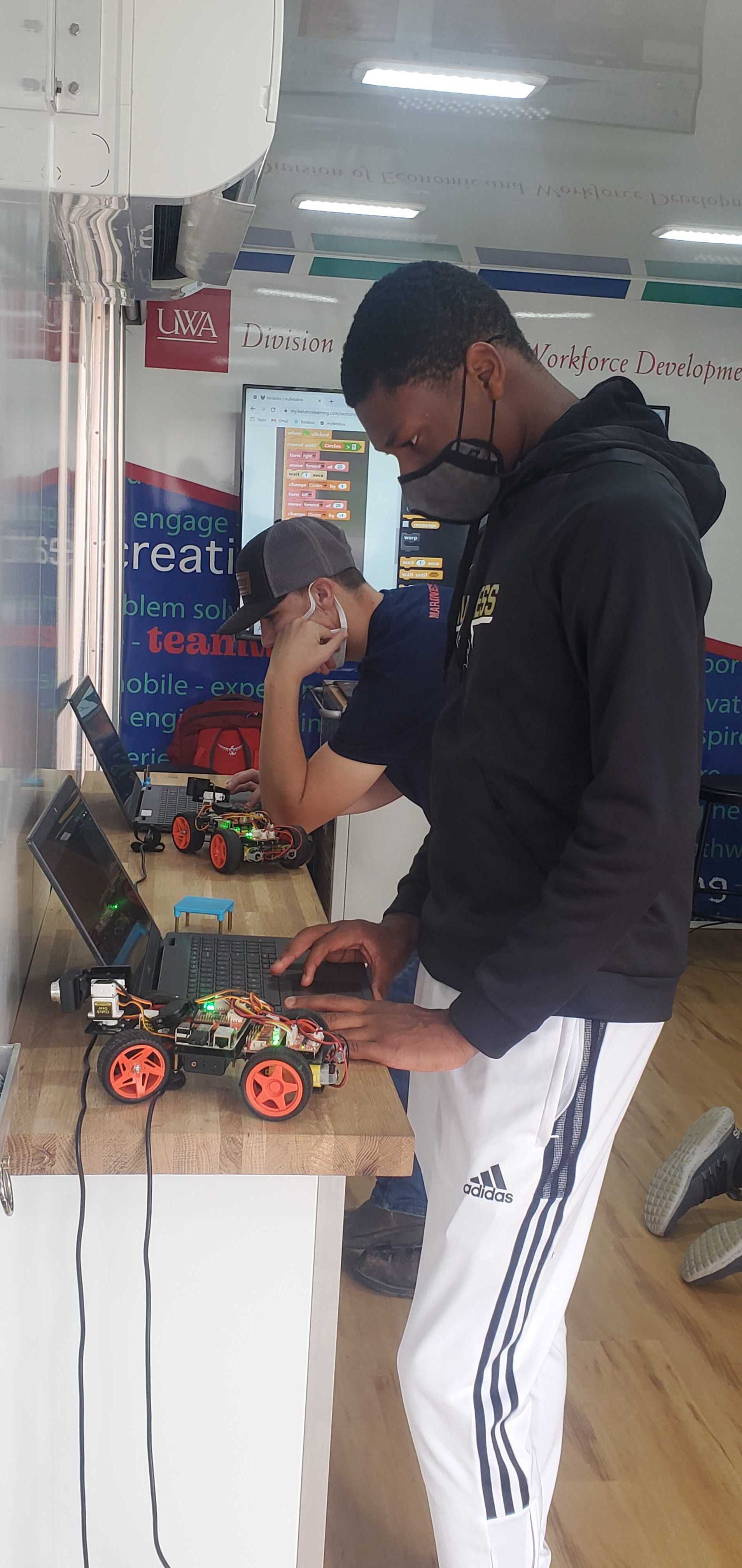Student with robotic car in Skills on Wheels unit