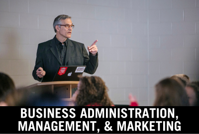 Click here to donate to the department of Business Administration, Management, and Marketing. Image of professor giving a lecture.