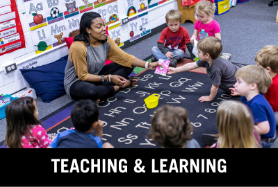 Click here to donate to the Department of Teaching and Learning. Image of student teaching in an elementary school setting.